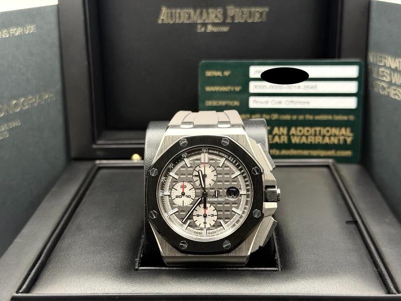 Audemars Piguet Royal Oak Offshore 26400IO 44mm Grey Dial Titanium Box Papers: Style Number: 26400IO / 26400IO.OO.A004CA.1 Model: Audemars Piguet Royal Oak Offshore Year: 2014 - 2021 Case Material: Titanium Band: Rubber Bezel: Black Ceramic Dial: Grey Crystal: Sapphire Case Size