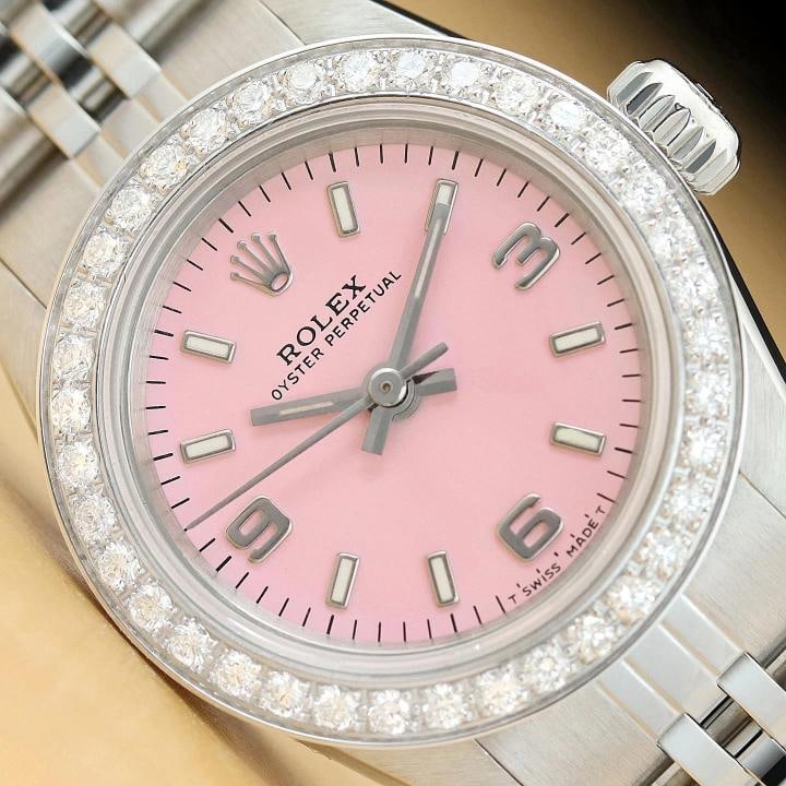 ROLEX LADIES OYSTER PERPETUAL 67180 PINK ARABIC DIAL DIAMOND BEZEL STEEL WATCH: This is an authentic Rolex Oyster Perpetual 67180 watch with custom stainless steel jubilee bracelet, Rolex arabic dial Ref., and custom 18K white gold diamond bezel. Descriptions: Brand: Rolex Model: