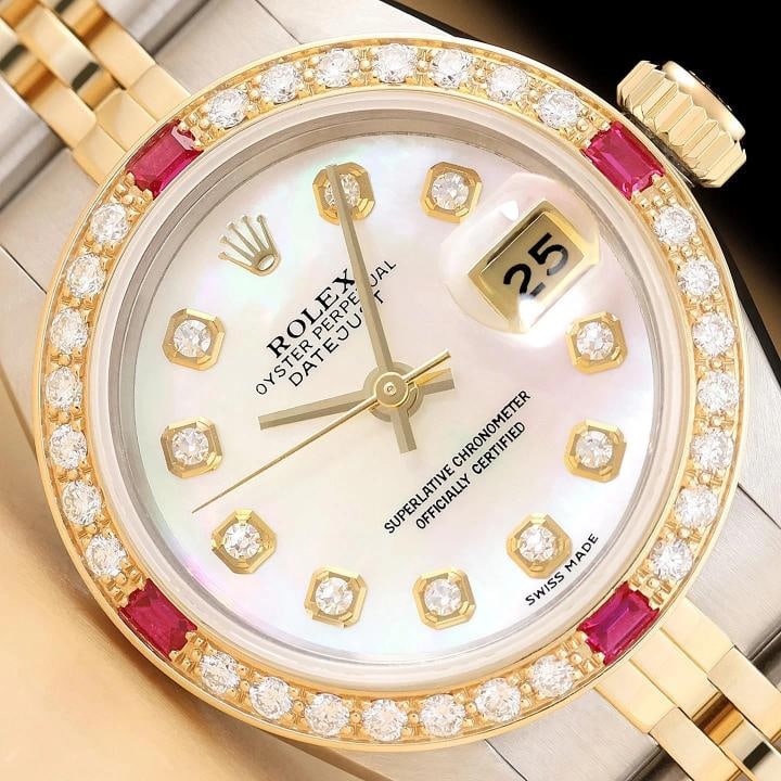 ROLEX LADIES DATEJUST 69173 MOTHER OF PEARL DIAMOND RUBY 18K GOLD STEEL WATCH: This is an authentic Rolex Datejust 69173 watch with Rolex 18K yellow gold and stainless steel jubilee bracelet, Rolex dial Ref. with added mother of pearl and diamond markers, and custom 18K yellow g