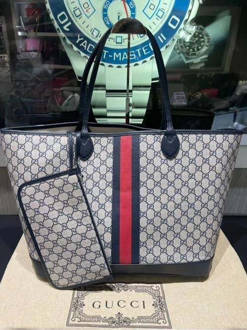 Gucci Navy GG Supreme Tote with Red/Navy Web & Matching Wristlet: Condition: Pre-owned - Good,Brand: Gucci,Accessories: Wristlet,Department: Women,Exterior Color: Navy,Style: Tote,Exterior Material: Supreme Canvas,Country of Origin: Italy This pre-owned Gucci Navy