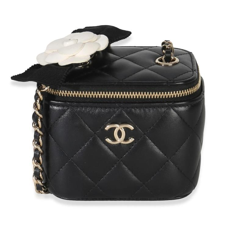 Chanel Black Quilted Lambskin Camellia Bow Chain Mini Vanity Case: Condition: Pre-owned - Good,Country of Origin: Italy,Dimensions: 4 x 3.25 x 2.5,Handbag Accessories: Dustbag;Authenticity Card,Bag Width: 4 in,Bag Depth: 2.5 in,Bag Height: 3.25 in,Department: