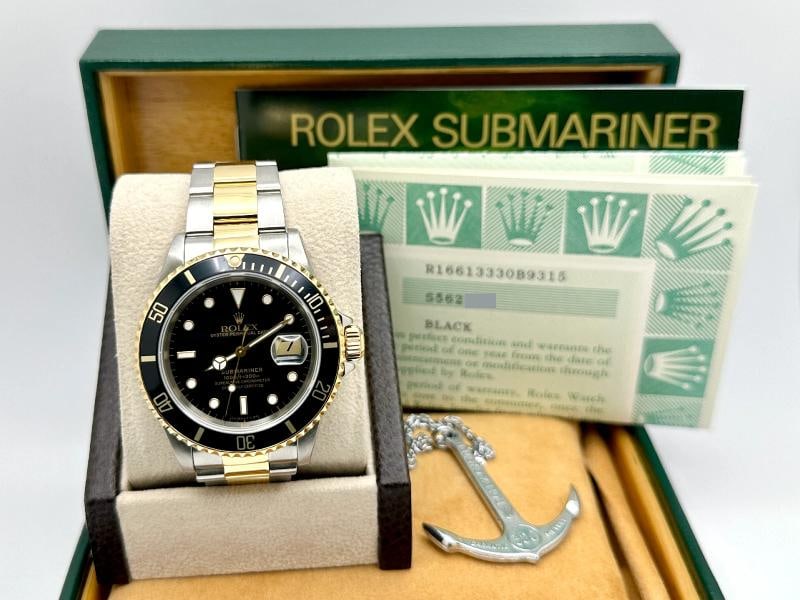 Rolex Submariner Black 16613 40mm 18k Yellow Gold Stainless Steel Box Paper: Style Number: 16613 Serial: S562*** Year: 1994 Model: Rolex Submariner Case Material: Stainless Steel Band: 18K Yellow Gold & Stainless Steel Bezel: Black Dial: Black Crystal: Sapphire Case Size: 40mm