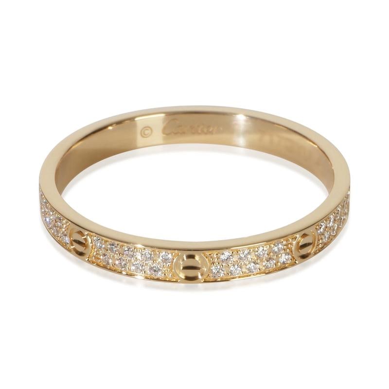 Cartier Yellow Gold Diamond Mini Pave Love Ring: Condition: Pre-owned,Shape: Round Brilliant,With Original Box/Packaging: Yes,Side Stone Type: Diamond,Side Stone Weight (cts): 0.19,Metal Purity: 18k,With Papers: No,Gross Weight (grams): 2.27,Departm