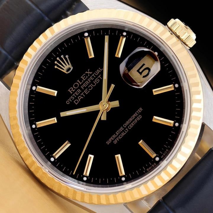 ROLEX MENS DATEJUST 16233 BLACK 18K GOLD STAINLESS STEEL BLUE LEATHER BAND WATCH: This is an authentic Rolex Datejust 16233 watch with Rolex stick dial Ref., Rolex 18K yellow gold fluted bezel, and custom genuine blue leather strap. Descriptions: Brand: Rolex Model: Datejust Refere