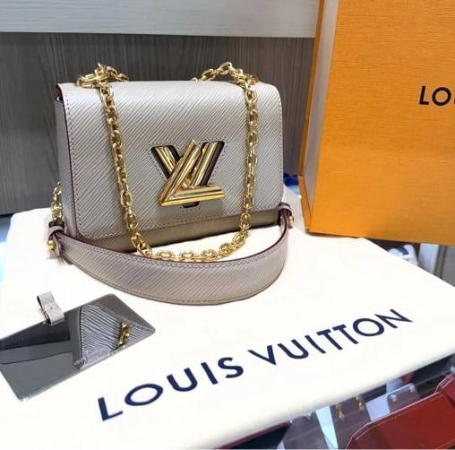 Louis Vuitton Twist Crossbody PM Galet Grey Epi Leather M21133: Condition: Pre-owned - Excellent,Bag Width: 3.5 in,Shape: Rectangle,Bag Height: 6 in,Closure: Turn Lock,Handle/Strap Color: Galet Grey,Size: Small,Hardware Color: Gold,Bag Depth: 7.5 in,Exterior Mater
