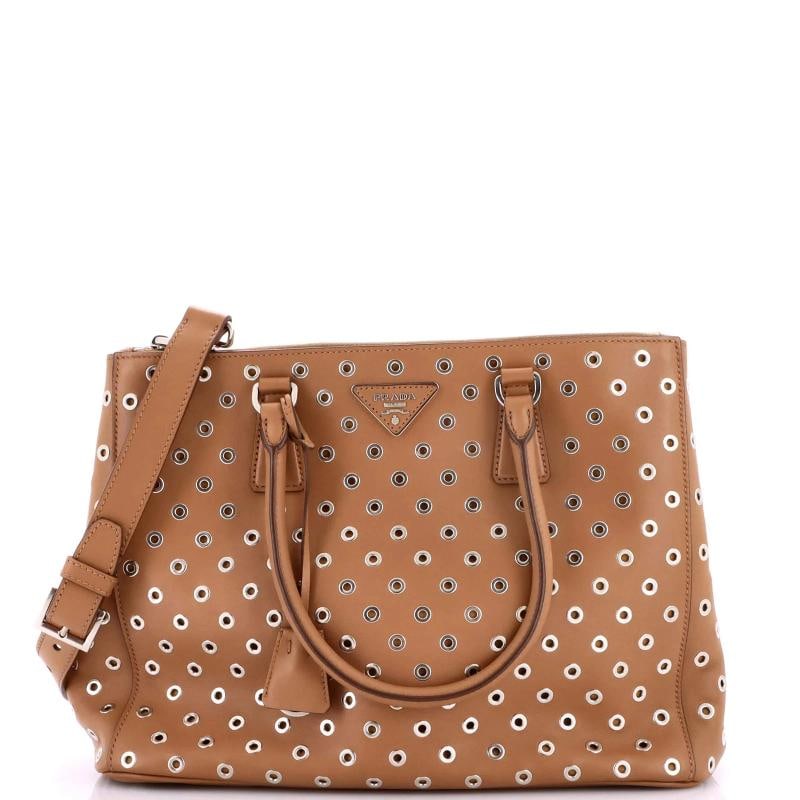 Prada Grommet Galleria Double Zip Tote City Calfskin Medium: Accessories: Clochette, Dust Bag, With Strap Measurements: Handle Drop 7", Height 10", Width 13.5", Depth 6", Strap Drop 22-23" . Condition: Pre-owned - Excellent,Brand: Prada,Exterior Material: