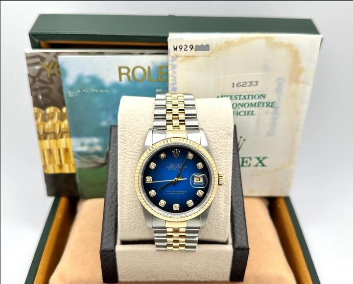Rolex Datejust 16233 Blue Vignette Diamond Dial 18K Gold Steel Box Papers: Style Number: 16233 Serial: W929*** Year: 1997 Model: Rolex Datejust Case Material: Stainless Steel Band: 18K Yellow Gold & Stainless Steel Bezel: 18K Yellow Gold Dial: Blue Vignette Diamond Dial Crys