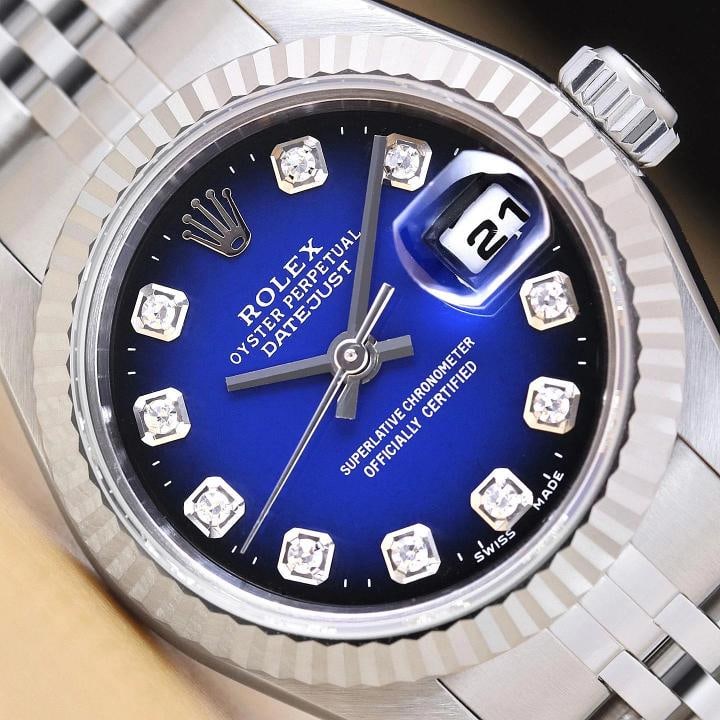 ROLEX LADIES DATEJUST 79174 BLUE VIGNETTE DIAMOND DIAL 18K WHITE GOLD SS WATCH: This is an authentic Rolex Datejust 79174 no holes watch with Rolex stainless steel jubilee bracelet, Rolex dial Ref. with added diamond markers, and Rolex 18K white gold fluted bezel. Descriptions: