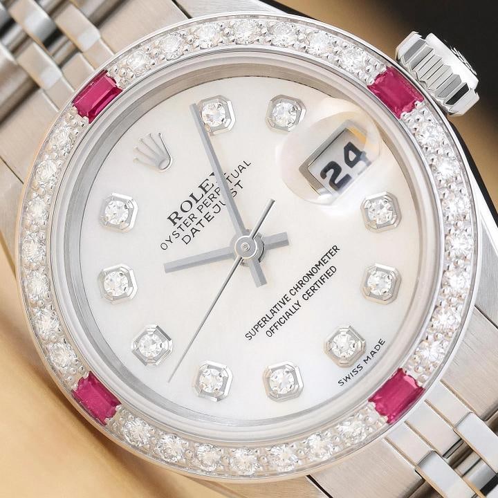 ROLEX LADIES DATEJUST 69174 18K GOLD MOTHER OF PEARL DIAMOND RUBY STEEL WATCH: This is an authentic Rolex Datejust 69174 watch with Rolex stainless steel jubilee bracelet, Rolex dial Ref. with added mother of pearl and diamond markers, and custom 18K white gold diamond and ruby 
