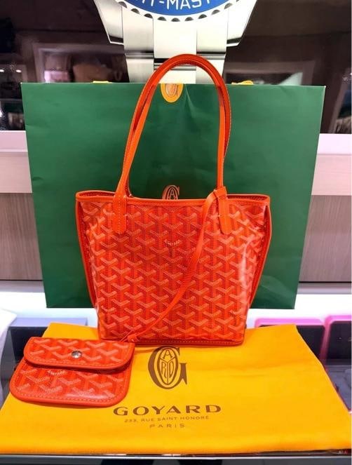 Goyard Mini Anjou Reversible Orange Coated Canva Tote Bag and Matching Wristlet: Condition: Pre-owned - Excellent,Brand: Goyard,Accessories: Dust Bag, Pochette,Department: Women,Size: Mini,Exterior Color: Orange,Model: Goyard Anjou,Style: Top Handle,Exterior Material: Canvas