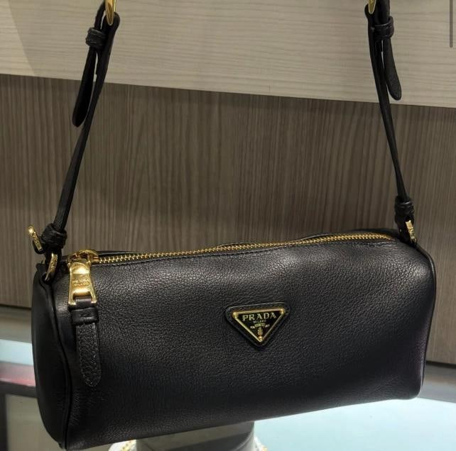 Prada Enameled Metal Triangle Leather Pouch Shoulder Bag: Condition: Pre-owned - Good,Brand: PRADA,Department: Women,Exterior Color: Black,Style: Shoulder Bag,Exterior Material: Leather,Country of Origin: Italy This pre-owned Prada Enameled Metal Triangle Le