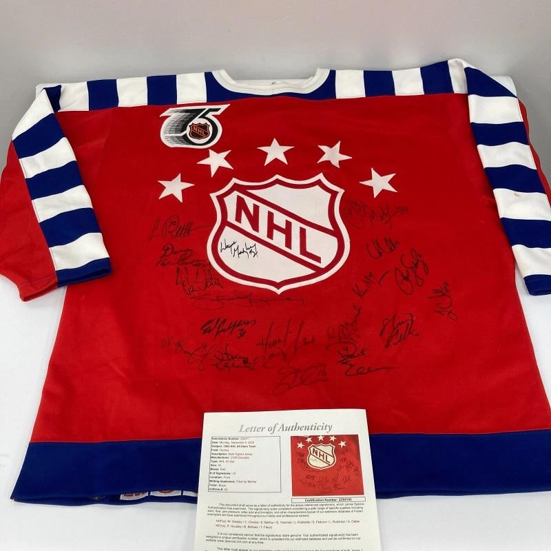 1992 NHL All Star Game Team Signed Authentic Jersey Wayne Gretzky JSA COA: signed by 19 players who participated in the game. The red number 92 jersey is a size 52. The jersey also features a fight strap and an NHL 75th Anniversary patch. The jersey has been signed on the fr
