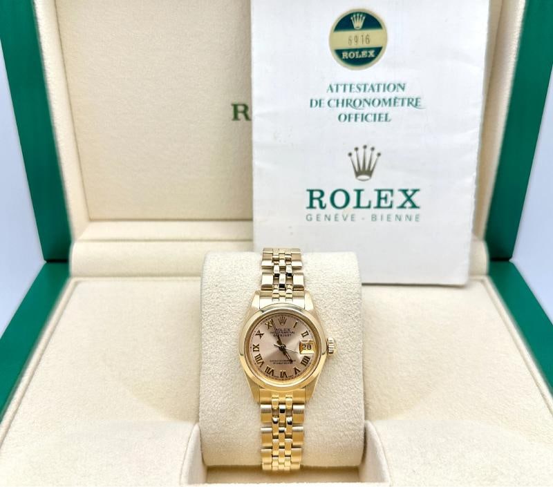 Rolex Ladies Datejust 6916 26mm Champagne Roman Dial 18K Yellow Gold Box Paper: Condition: Pre-owned - Good,Bezel Color: Gold, Yellow,Indices: Roman Numerals,Year Manufactured: 1980-1989,Band/Strap: Bracelet,Case Color: Gold, Yellow,Department: Women,Bezel Type: Smooth,Watch Shap