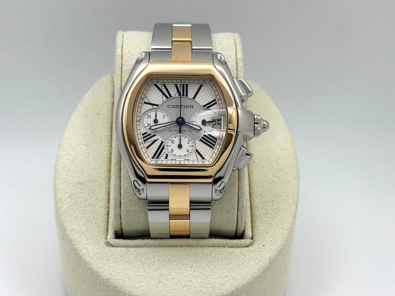 Cartier Roadster Chronograph XL 2618 W62027Z1 43mm Silver Dial 18K Gold Steel: Style Number: 2618 / W62027Z1 Year: 2002-2012 Model: Cartier Roadster Chronograph XL Case Material: Stainless Steel Band: 18k Yellow Gold and Stainless Steel Bezel: 18k Yellow Gold Dial: Silver Roman