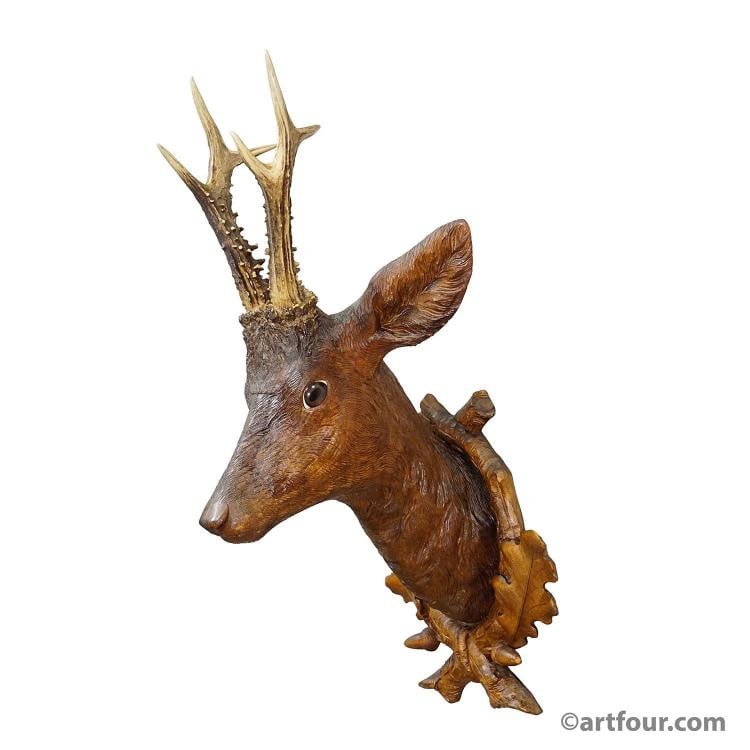 Large Naturalistic Black Forest Carved Deer Trophy, ca. 1920s: Country of Origin: Germany A rare antique wooden carved Black Forest red deer head handcarved in naturalistic style and fitted with real deer antlers. The head is mounted upon an elaborate,