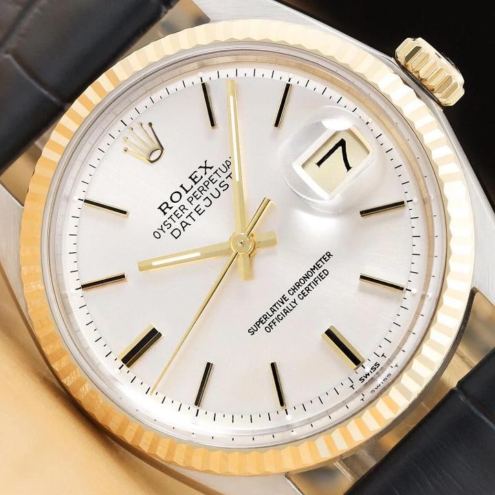 ROLEX DATEJUST 1601 SILVER 14K YELLOW GOLD STEEL BLUE LEATHER BAND WATCH: This is an authentic Rolex Datejust 1601 watch with Rolex stick dial Ref., Rolex 14K yellow gold fluted bezel, and custom genuine blue leather bracelet. Descriptions: Brand: Rolex Model: Datejust
