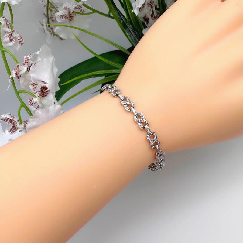 Round Diamond Infinity Tennis Bracelet in 14kt White Gold: Condition: Pre-owned - Excellent,Number of Diamonds: 180,Main Stone Creation: Natural,Signed: Yes,Color: White,Main Stone Color: White/Colorless,Material: white gold,Metal: White Gold,Item Length: 7