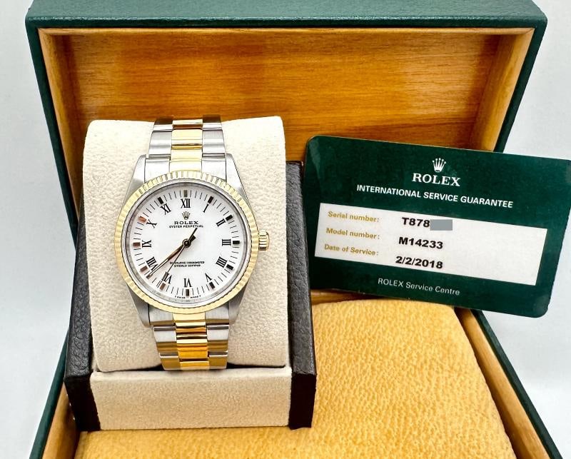 Rolex Oyster Perpetual 14233 34mm White Dial 18k Gold Steel Box Service Card: Style Number: 14233 Serial: T878*** Year: 1996 Model: Rolex Oyster Perpetual Case Material: Stainless Steel Band: 18K Yellow Gold & Stainless Steel Bezel: 18K Yellow Gold Dial: White Roman Numeral