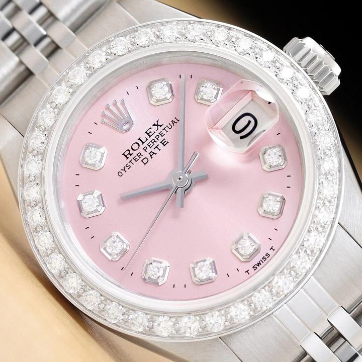 LADIES ROLEX DATE 6917 PINK DIAMOND DIAL 18K WHITE GOLD STAINLESS STEEL WATCH: This is an authentic Rolex Datejust 6917 watch with Rolex dial Ref. with added diamond markers, custom 18K white gold diamond bezel, and custom stainless steel jubilee band.Descriptions: Brand: Rolex