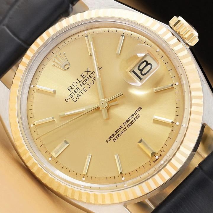 ROLEX DATEJUST 1601 14K YELLOW GOLD STEEL CHAMPAGNE DIAL BLUE LEATHER BAND WATCH: This is an authentic Rolex Datejust 1601 watch with Rolex stick dial Ref., Rolex 14K yellow gold fluted bezel, and custom genuine blue leather bracelet. Descriptions: Brand: Rolex Model: Datejust