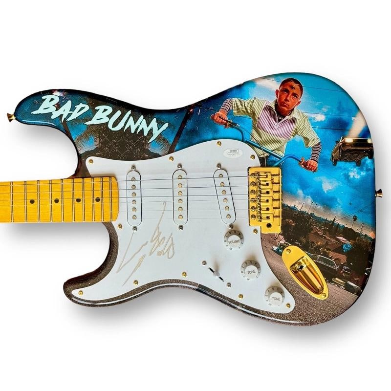 Bad Bunny Signed Guitar Custom Graphics JSA COA Benito Martinez YHLQMDLG: Signer: Bad Bunny (Benito Martinez) Item Type: Left-Handed Full Size Autograph Edition Stratocaster Style Guitar Guitar Size: 39in in length Item Certification: This item is guaranteed authentic and