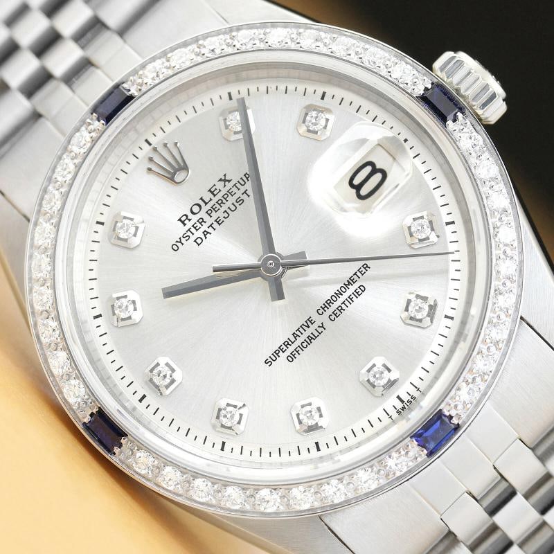 MENS ROLEX DATEJUST 1603 SILVER DIAMOND SAPPHIRE 18K GOLD STAINLESS STEEL WATCH: This is an authentic Rolex Datejust 1603 watch with Rolex dial Ref. with added diamond hour markers, custom 18K white gold sapphire diamond bezel, and custom stainless steel jubilee bracelet. Descript