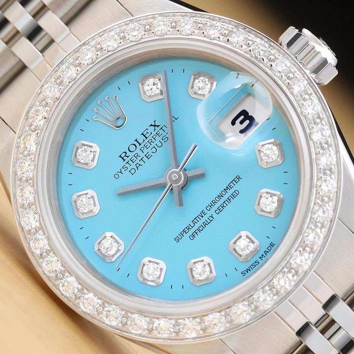 ROLEX LADIES DATEJUST 69174 AQUA BLUE DIAMOND 18K WHITE GOLD STEEL WATCH: This is an authentic Rolex Datejust 69174 watch with Rolex stainless steel jubilee bracelet, Rolex dial Ref. with added diamond markers, and custom 18K white gold diamond bezel. Descriptions: Brand: