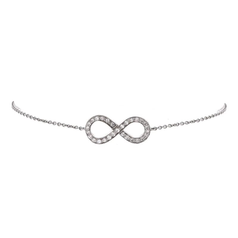 Tiffany & Co. Infinity Bracelet Platinum with Diamonds: Estimated Retail Price: $2,300 Condition: Very good. Moderate wear throughout. Accessories: No Accessories Designer: Tiffany & Co. Model: Infinity Bracelet Platinum with Diamonds Exterior Color: