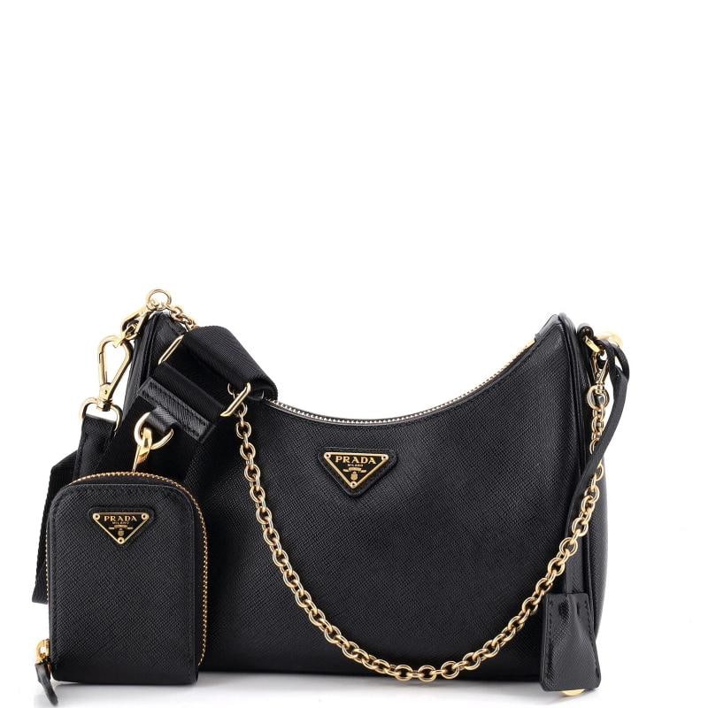 Prada Re-Edition 2005 Shoulder Bag Saffiano Leather Small: Accessories: Clochette, Pochette, Extra Strap, With Strap Measurements: Handle Drop 9.5", Height 5", Width 8.5", Depth 2.5", Strap Drop 15-21.5". Condition: Pre-owned - Excellent,Brand: Prada,Exterior