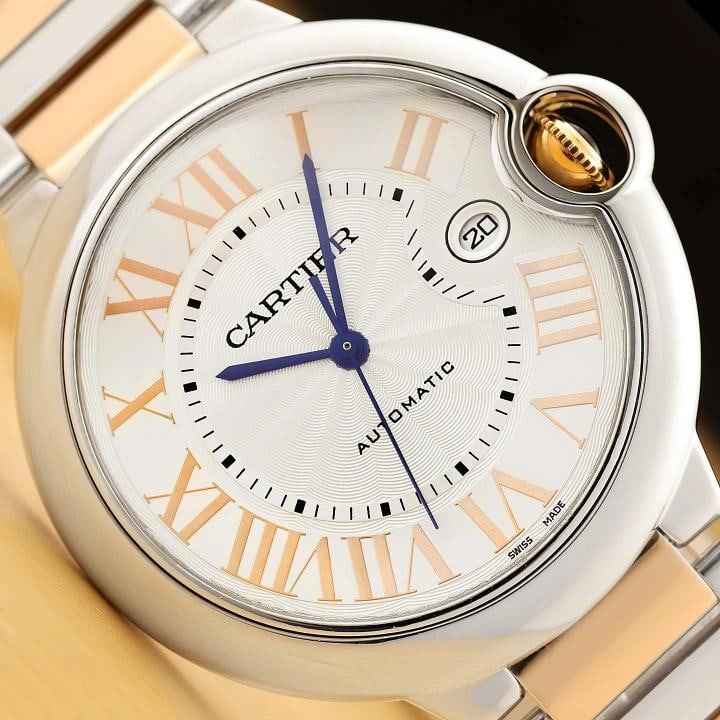 CARTIER BALLON BLEU 42MM W6920095 ROMAN 18K ROSE GOLD STAINLESS STEEL WATCH: This is an authentic Cartier Ballon Bleu W6920095 42MM watch with silver dial and roman numeral hour markersÃ¢â‚¬â€¹, stainless steel bezel, and 18K rose