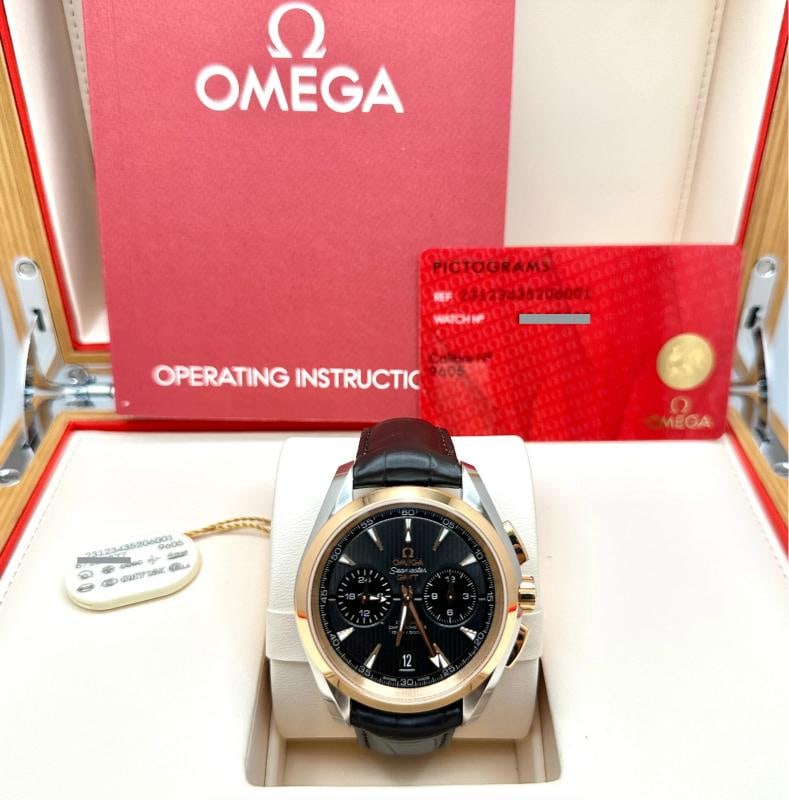Omega Seamaster Aqua Terra GMT 231.23.43.52.06.001 43mm 18k Gold Steel Box Paper: Style Number: 231.23.43.52.06.001 Model: Omega Seamaster Aqua Terra 150M GMT Chronograph - Factory stickers Case Material: Stainless Steel Band: Brown Leather Bezel: 18k Rose Gold Dial: Grey Teak