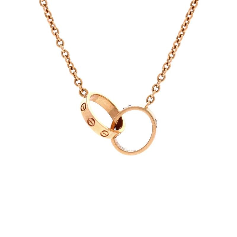 Cartier Love Interlocking Necklace 18K Rose Gold: Measurements: Length: 17.25 ", Pendant Length: 0.75 ", Pendant Width: 2.60 mm . Condition: Pre-owned - Good,Brand: Cartier,Main Stone: Unknown,Metal: 18K Rose Gold,Metal Purity: 18K,Style: