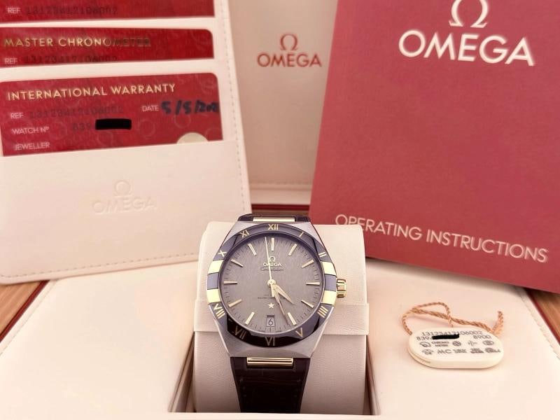 Omega Constellation 131.23.41.21.06.002 41mm 18K Yellow Gold Steel Box Paper: Style Number: 131.23.41.21.06.002 Year: 2021 Model: Omega Constellation Case Material: Stainless Steel Band: Leather Bezel: 18K Yellow Gold and Ceramic Dial: Grey Crystal: Sapphire Case Size: 41mm Inc