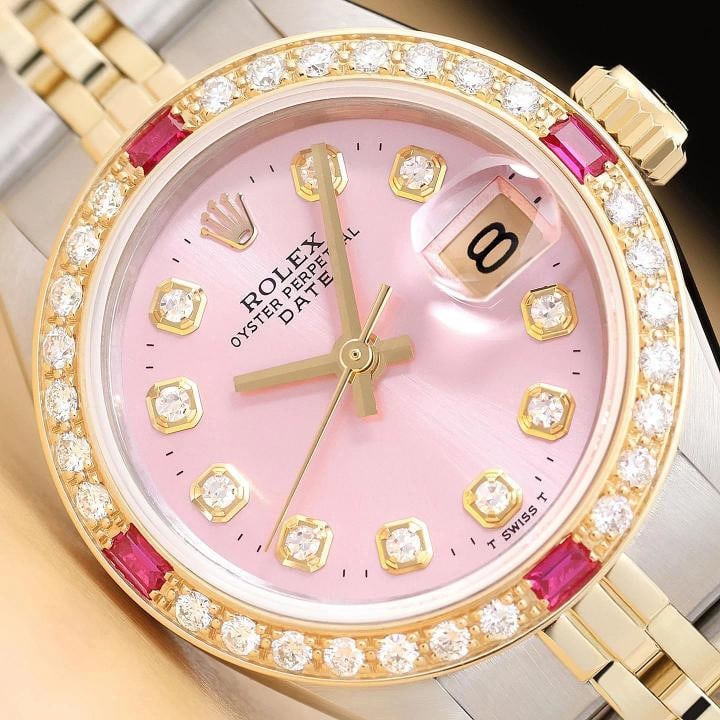 ROLEX LADIES DATE 6917 PINK DIAL DIAMOND RUBY 14K YELLOW GOLD STEEL 2-TONE WATCH: This is an authentic Rolex Date 6917 watch with Rolex 14K yellow gold and stainless steel jubilee band, custom yellow gold diamond and ruby bezel, and Rolex dial Ref. with added diamond markers. Descr