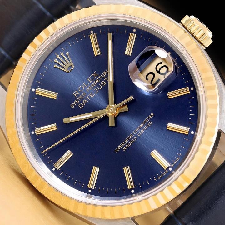 ROLEX MENS DATEJUST 16233 BLUE DIAL 18K GOLD STEEL BLUE LEATHER BAND WATCH: This is an authentic Rolex Datejust 16233 watch with Rolex stick dial Ref., Rolex 18K yellow gold fluted bezel, and custom genuine blue leather strap. Descriptions: Brand: Rolex Model: Datejust Refere