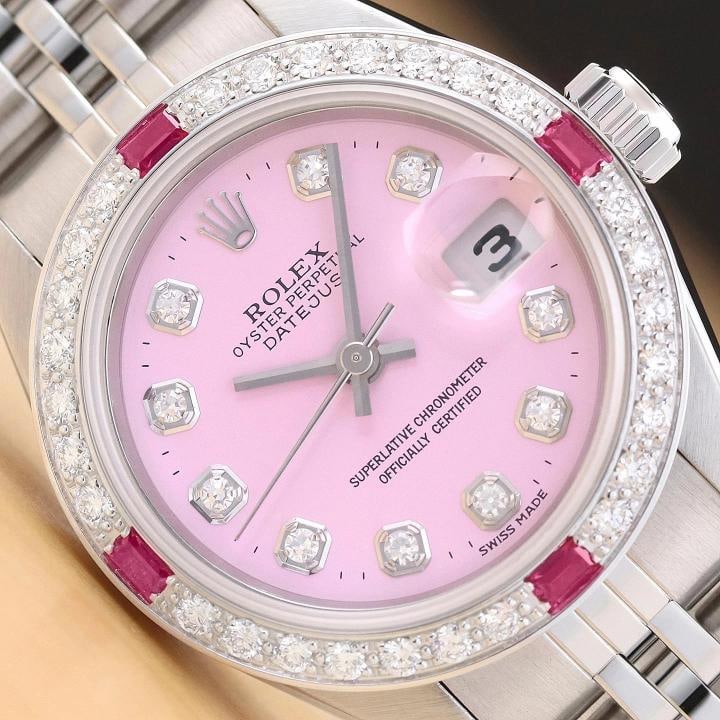 ROLEX LADIES DATEJUST 79174 18K GOLD STEEL PINK DIAL DIAMOND RUBY BEZEL WATCH: This is an authentic Rolex Datejust 79174 no holes watch with Rolex stainless steel jubilee bracelet, Rolex dial Ref. with added diamond markers, and custom 18K white gold diamond and ruby bezel.