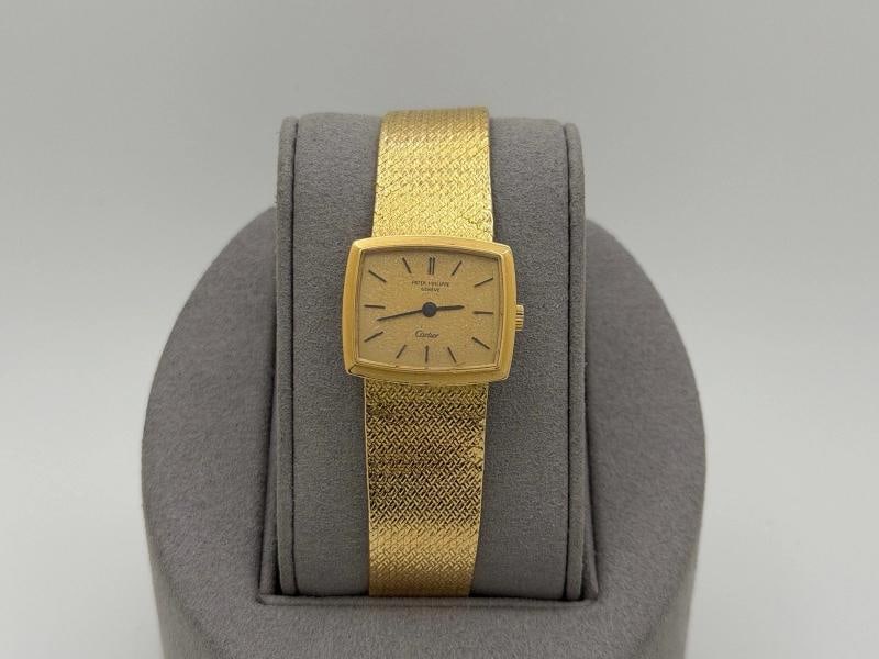 Vintage Patek Philippe Ladies 3352/1 RARE Cartier Signed Dial 18k Yellow Gold: Style Number: 3352/1 Serial: 19*** Year: ~1970s Case Material: 18k Yellow Gold Band: 18k Yellow Gold Bezel: 18k Yellow Gold Dial: RARE Cartier Signature Dial Crystal: Sapphire Case Size: 23mm Includes