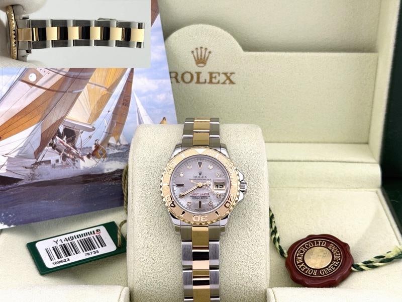 Rolex Yacht Master 169623 Mother of Pearl Sapphire Diamond Dial 18k Gold Steel: Style Number: 169623 Serial: Y14**** Year: 2002 Model: Rolex Ladies Yacht Master Case Material: Stainless Steel Band: 18k Yellow Gold & Stainless Steel Bezel: 18k Yellow Gold Dial: Factory Mother of P