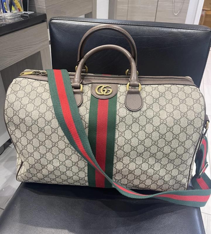 Gucci Ophidia Medium Weekender Duffle (Style 547953): Condition: Pre-owned - Excellent,Brand: Gucci,Department: Men,Closure: Zip,Color: Beige & Brown,Style: Duffle,Material: coated canvas,Fabric Type: Canvas,Country of Origin: Italy This pre-owned Gucci 