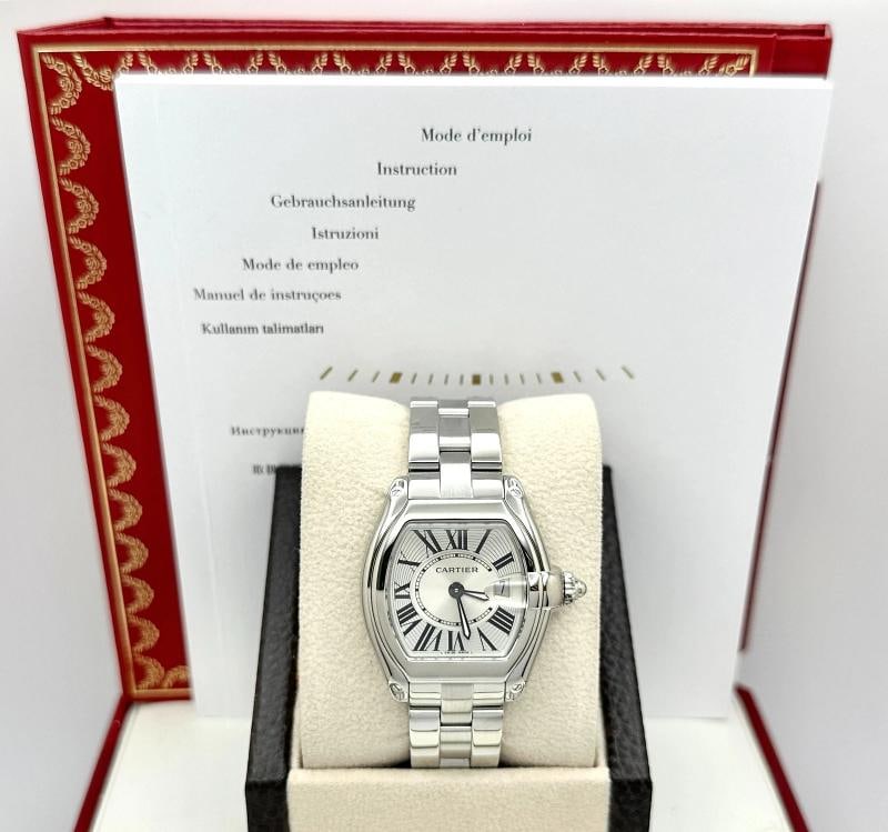 Cartier Roadster 2675 31mm Stainless Steel Box Booklet: Style Number: 2675 Year: 2001 - 2012 Model: Cartier Roadster Case Material: Stainless Steel Band: Stainless Steel Bezel: Stainless Steel Dial: Silver Crystal: Sapphire Case Size: 31mm Includes: -