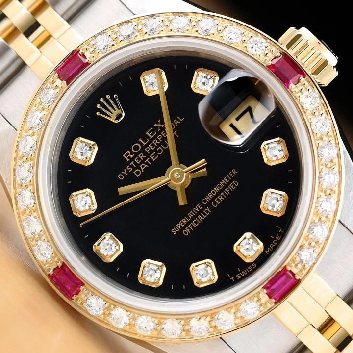 ROLEX LADIES DATEJUST 69173 BLACK FACTORY DIAMOND DIAL 18K GOLD STEEL RUBY WATCH: This is an authentic Rolex Datejust 69173 watch with Rolex 18K yellow gold and stainless steel jubilee bracelet, factory Rolex diamond dial Ref., and custom 18K yellow gold ruby diamond bezel. Descrip