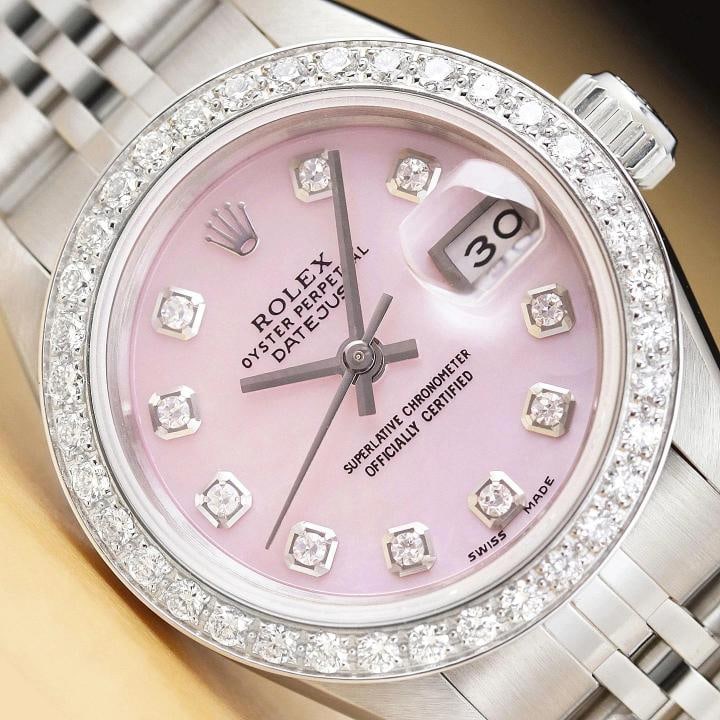 ROLEX LADIES DATEJUST 69174 PINK MOTHER OF PEARL 18K GOLD STEEL DIAMOND WATCH: This is an authentic Rolex Datejust 69174 watch with Rolex stainless steel jubilee bracelet, Rolex dial Ref. with added mother of pearl and diamond markers, and custom 18K white gold diamond bezel. De
