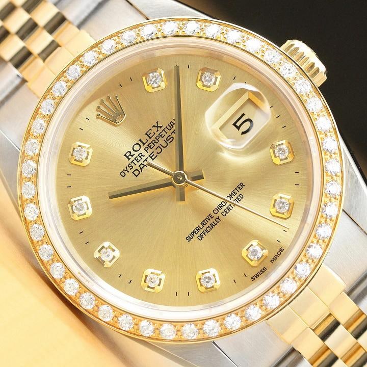 ROLEX MENS DATEJUST 16233 CHAMPAGNE 18K GOLD STAINLESS STEEL DIAMOND WATCH: This is an authentic Rolex Datejust 16233 watch with two tone 18K yellow gold and stainless steel jubilee bracelet, Rolex dial Ref. with added genuine diamond markers, and custom 18K yellow gold diamo