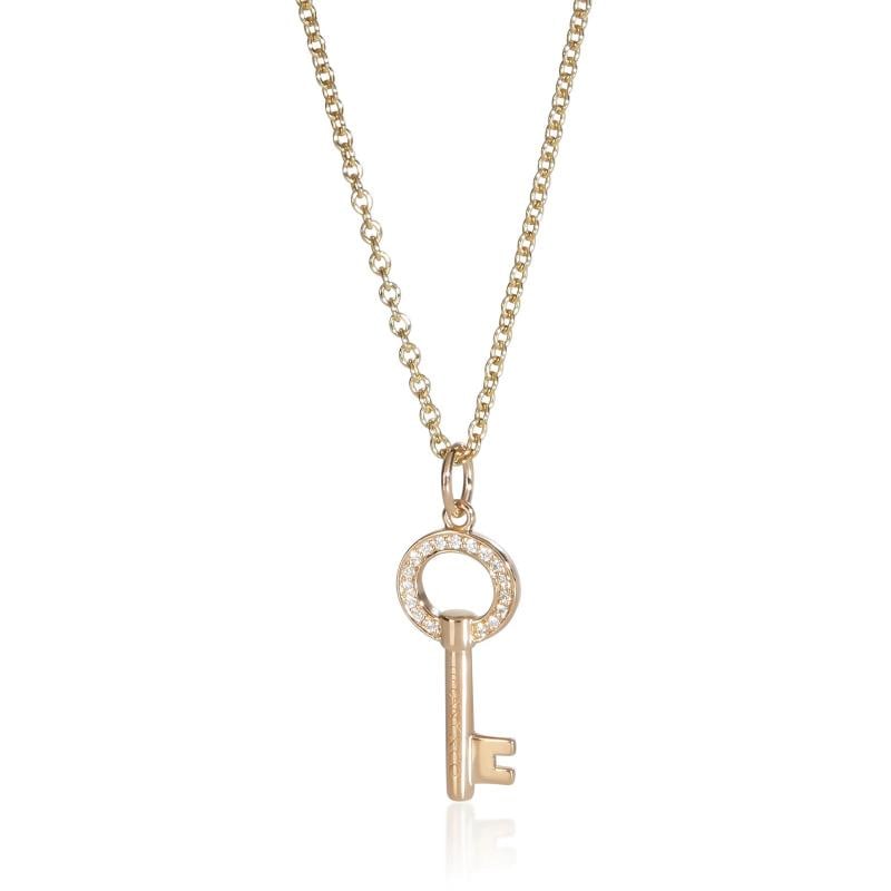 Tiffany & Co. Yellow Gold Diamond Mini Modern Open Round Key Pendant: Condition: Pre-owned,Clasp/Buckle Type: Spring Ring,With Original Box/Packaging: Yes,Side Stone Type: Diamond,Side Stone Weight (cts): 0.04,Metal Purity: 18k,With Papers: No,Gross Weight (grams): 4.27