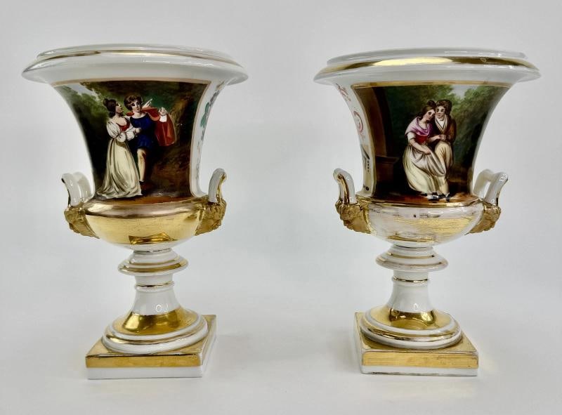 Pair c1850s Continental European Hand Painted Courting Scene Urns: Each urn stands about 9 1/2 inches tall and measures about 6 5/8 inches in diameter, with a 3 3/8 inch square base. . Condition: Used: An item that has been used previously. The item may have some