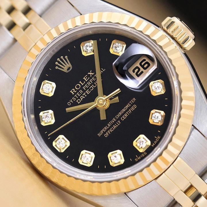 ROLEX LADIES DATEJUST 79173 BLACK DIAMOND DIAL 18K GOLD STEEL TWO TONE WATCH: This is an authentic Rolex Datejust 79173 no holes watch with Rolex 18K yellow gold and stainless steel jubilee bracelet, Rolex dial Ref. with added diamond markers, and Rolex 18K yellow gold fluted