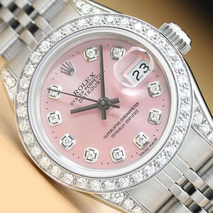 ROLEX LADIES DATEJUST 69174 PINK DIAL DIAMOND BEZEL LUGS 18K GOLD STEEL WATCH: This is an authentic Rolex Datejust 69174 watch with Rolex stainless steel jubilee band, Rolex dial Ref. with added genuine diamond markers, custom 18K white gold diamond bezel, and added diamonds on