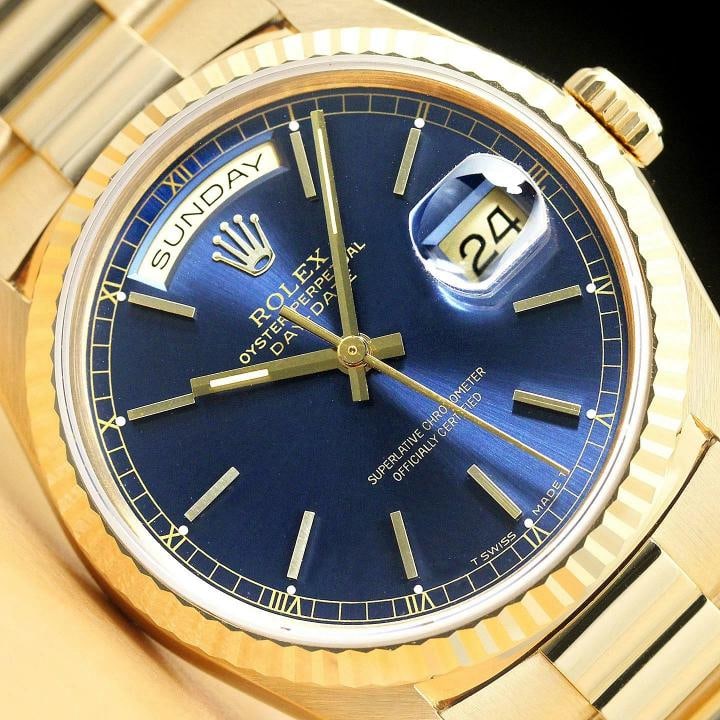 ROLEX MENS PRESIDENT DAY-DATE BLUE DIAL 18K YELLOW GOLD DOUBLE QUICKSET WATCH: This is an authentic Rolex Day-Date 18238 watch with 18K yellow gold president bracelet, Rolex stick dial Ref., Rolex 18K yellow gold fluted bezel, and factory Rolex box. Descriptions: Brand: Rolex Mo