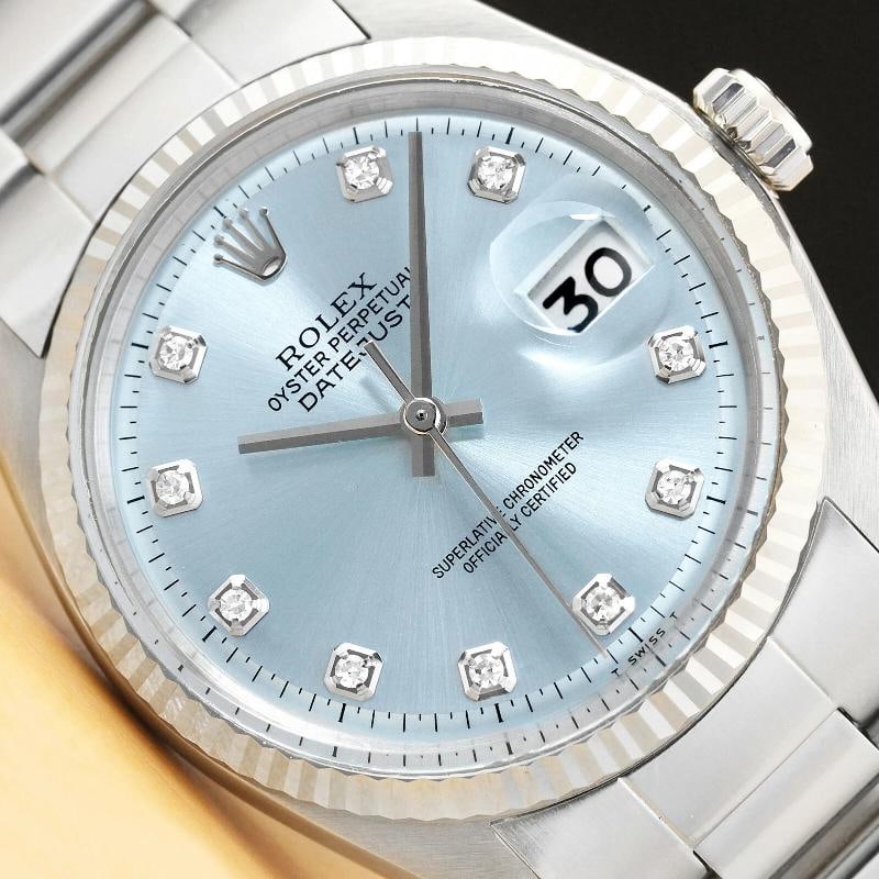 MENS ROLEX DATEJUST 1601 ICE BLUE 18K WHITE GOLD BEZEL STAINLESS STEEL WATCH: This is an authentic Rolex Datejust 1601 watch with Rolex 18K white gold fluted bezel, Rolex dial Ref. with added diamond hour markers, and custom stainless steel oyster bracelet. Descriptions: