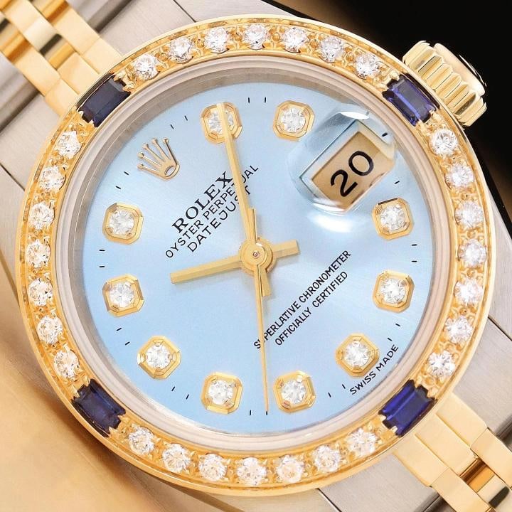 ROLEX LADIES DATEJUST 69173 ICE BLUE DIAMOND SAPPHIRE 18K GOLD STEEL WATCH: This is an authentic Rolex Datejust 69173 watch with Rolex 18K yellow gold and stainless steel jubilee bracelet, Rolex dial Ref. with added diamond markers, and custom 18K yellow gold diamond and sapp